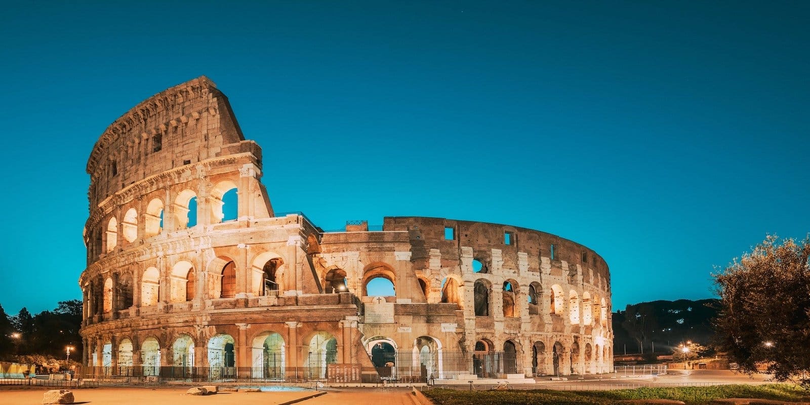 Rome, Italy. Colosseum Also Known As Flavian Amphitheatre In Evening Or Night Time