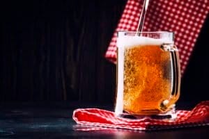 Two glasses of german light beer, beer poured into mug