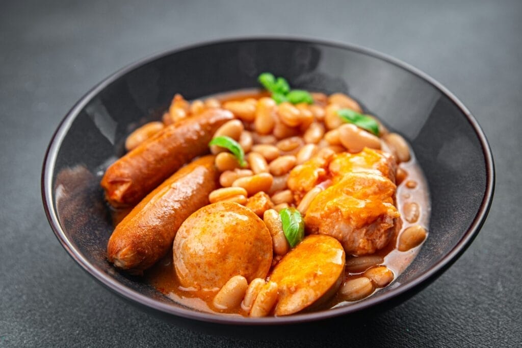 cassoulet thick bean soup meat, beans, sausages eating cooking appetizer meal food snack
