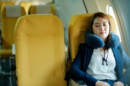 Businesswoman resting on plane.