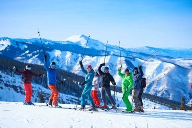 Group portrait of male and female skiers on ski slope, Aspen, Colorado, USA
