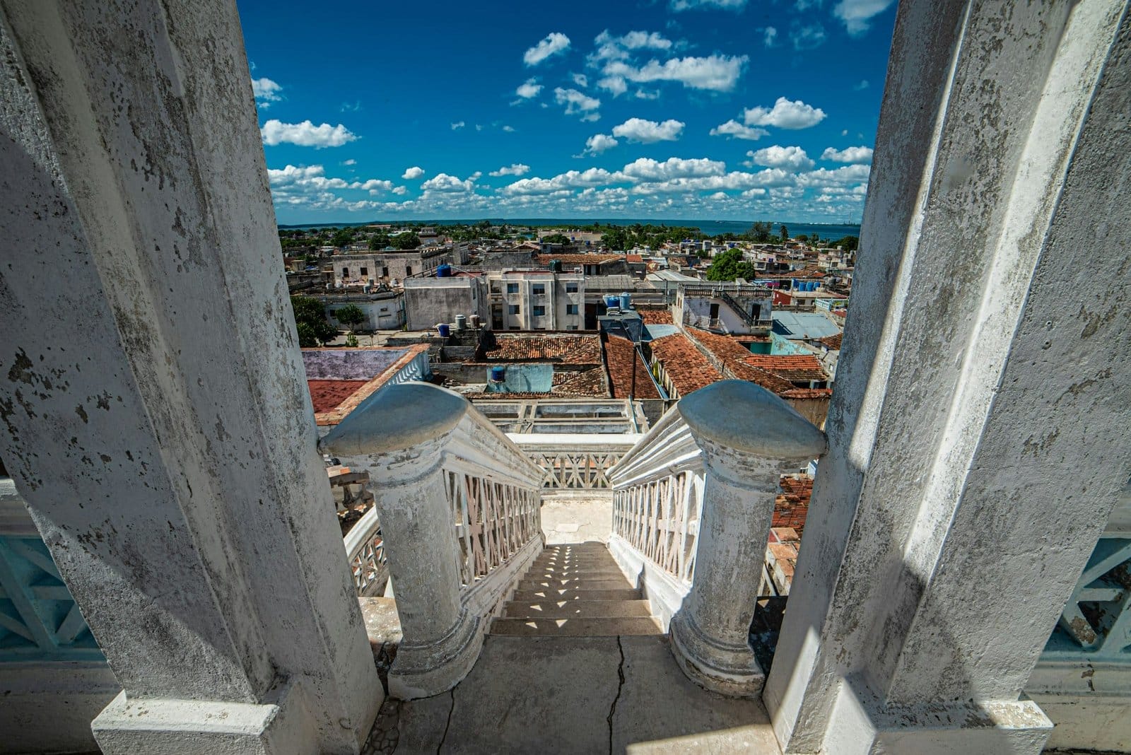 High angle shot of white stairs leading down to Cienfuegos city in Cuba