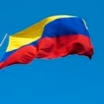 A Colombian flag is streaming in the wind.