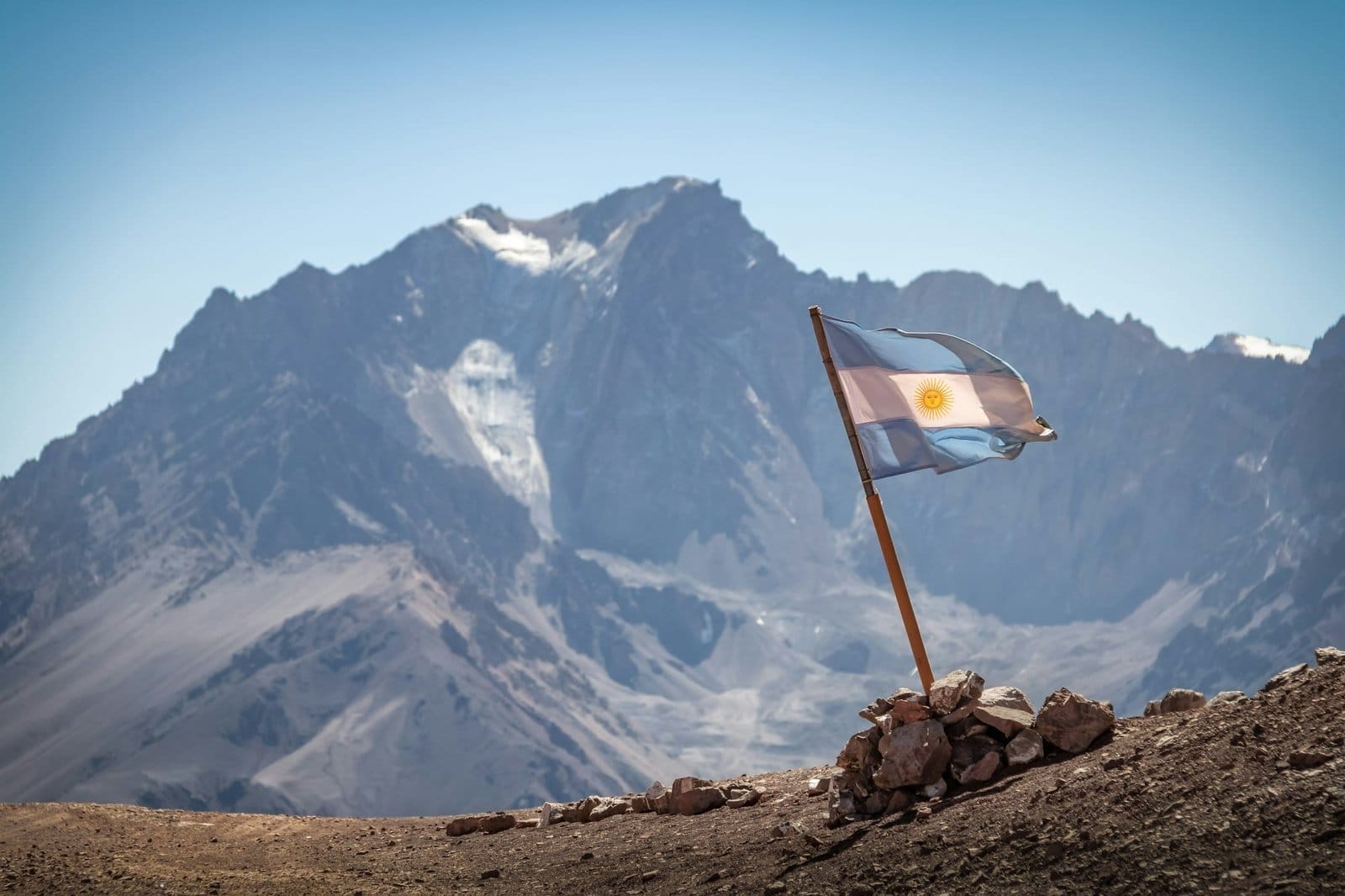 Argentina flag with Cerro Tolosa Mountain in Cordillera de Los Andes - Mendoza Province, Argentina