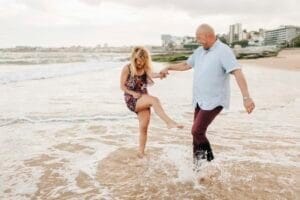 Couple having fun on beach, Estoril, Lisboa, Portugal