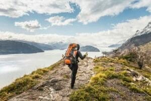 Rear view of female hiker hiking alongside Grey glacier lake, Torres del Paine National Park, Chile