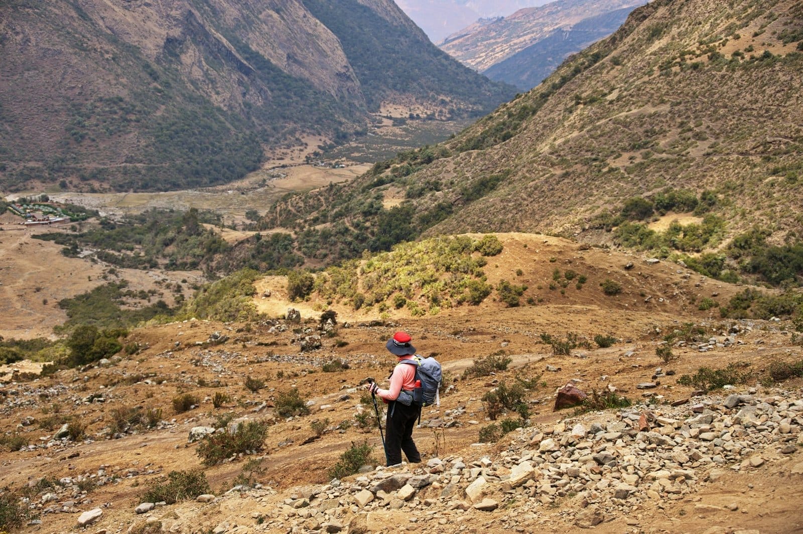 Senior woman hiking down the mountain slope in Peru
