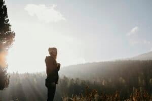 Switzerland, Engadin, woman on a hiking trip in mountain forest