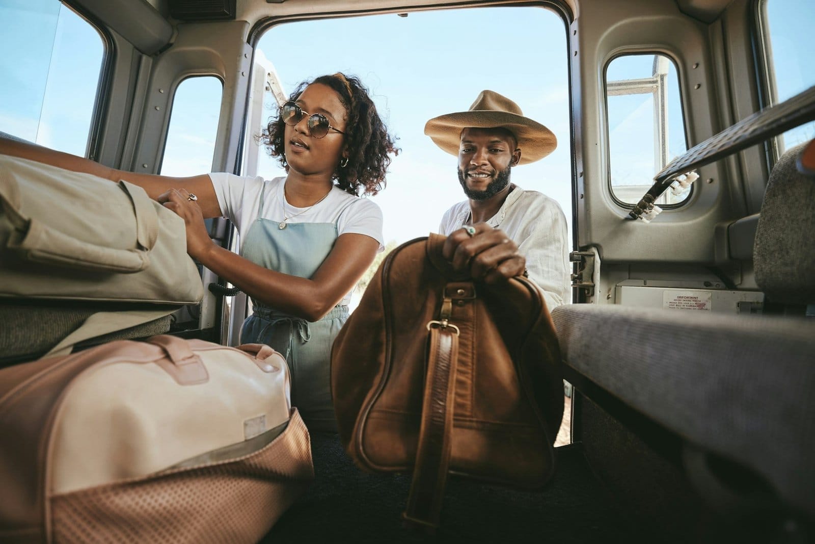 Black couple, travel and packing for road trip, journey or adventure with bags together. Happy Afri