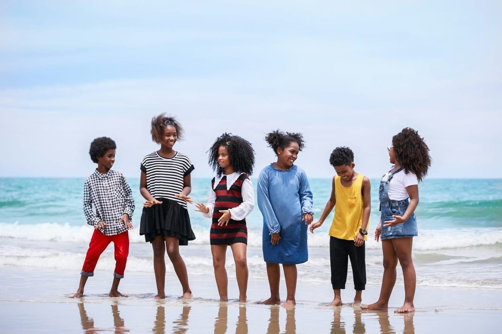 Funny vacation. Children or kids playing and romping together at the beach on holiday.