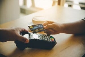 Close up of hand using credit card to pay by sending the credit card