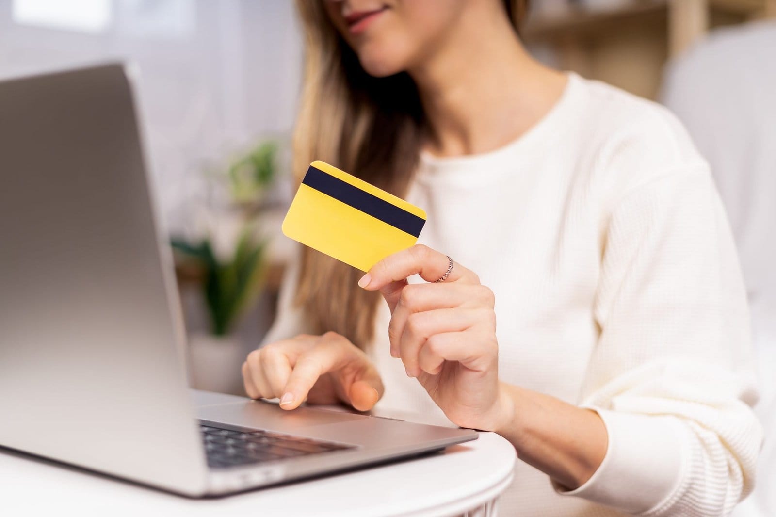 Distance learning online education and work. Business woman with credit car typing at laptop, sittin