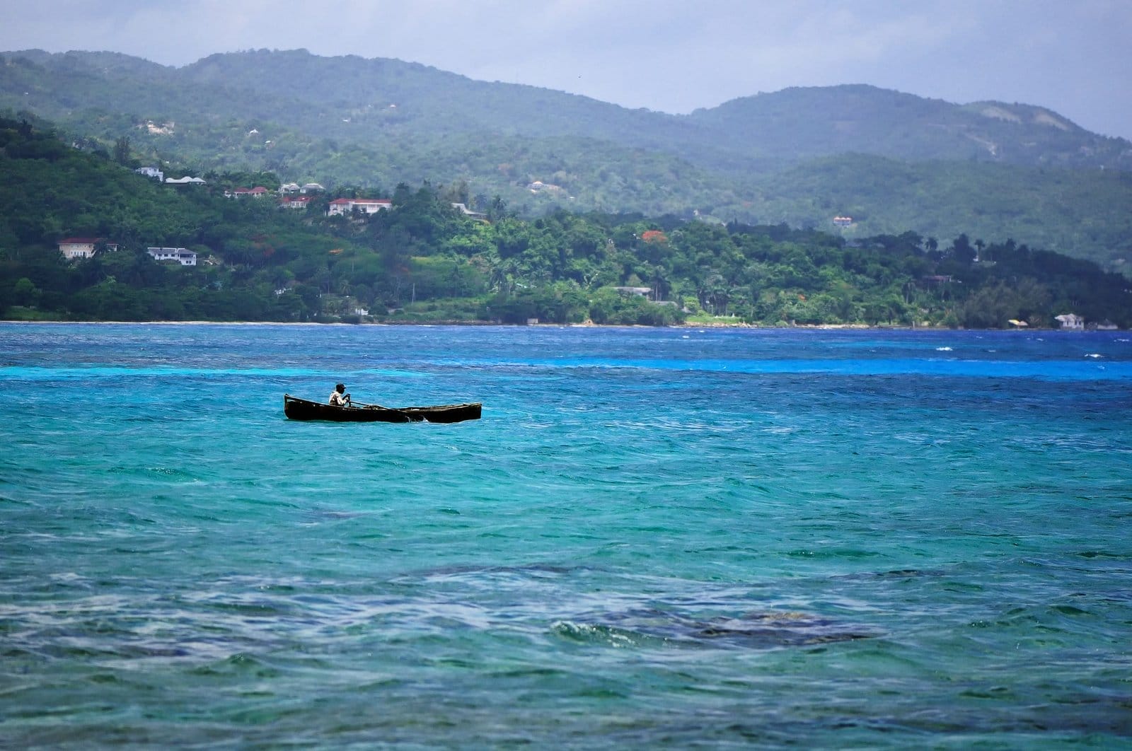 Silhouette of fisherman at stormz sea. Montego bay beach, Jamaica