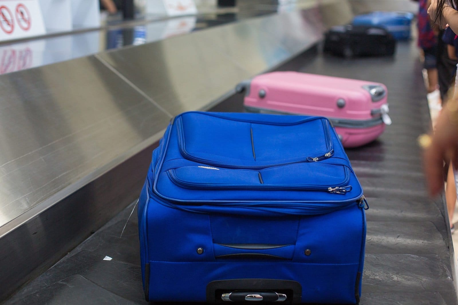 suit case on luggage conveyor belt at baggage claim in airport terminal. Baggage claim at airport