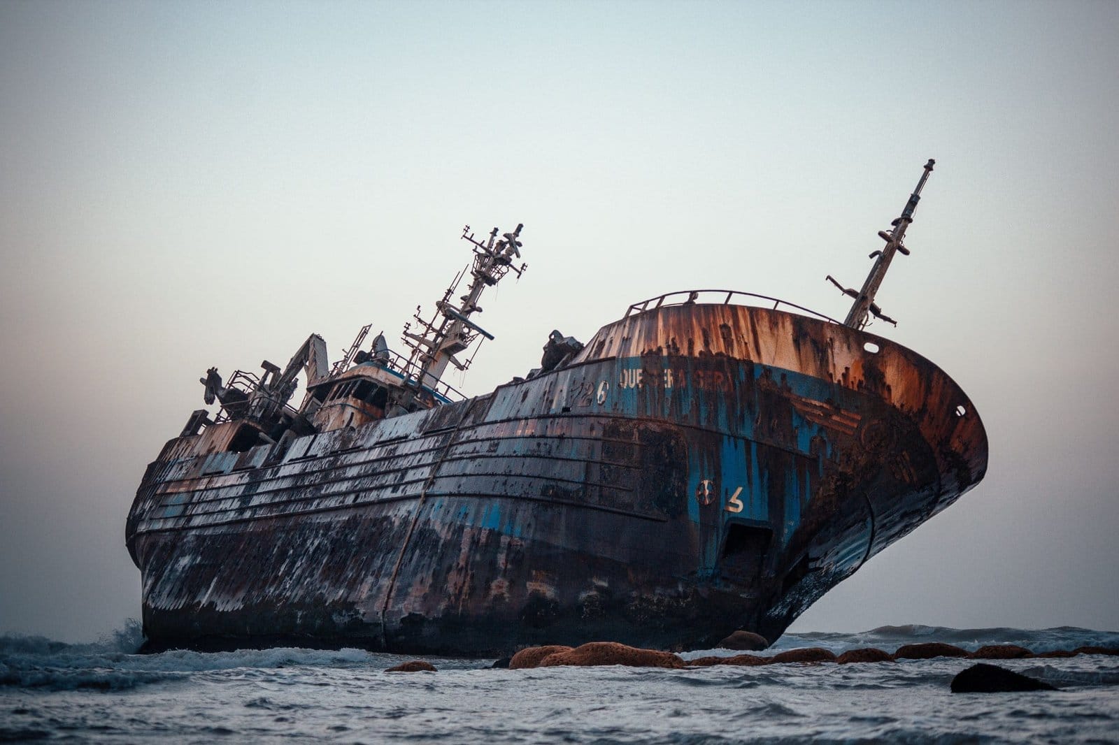 Beautiful shot of a historic dirty old ship after a shipwreck on a seashore