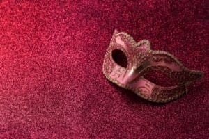 Carnival mask on red glitter