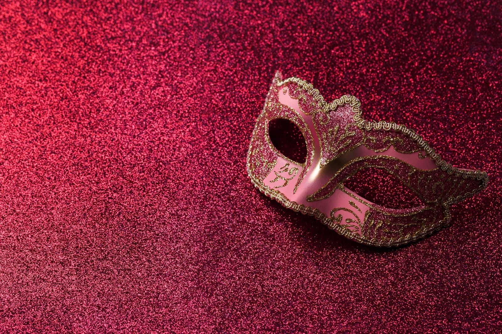 Carnival mask on red glitter