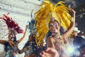 Cropped shot of beautiful samba dancers performing in a carnival with their band
