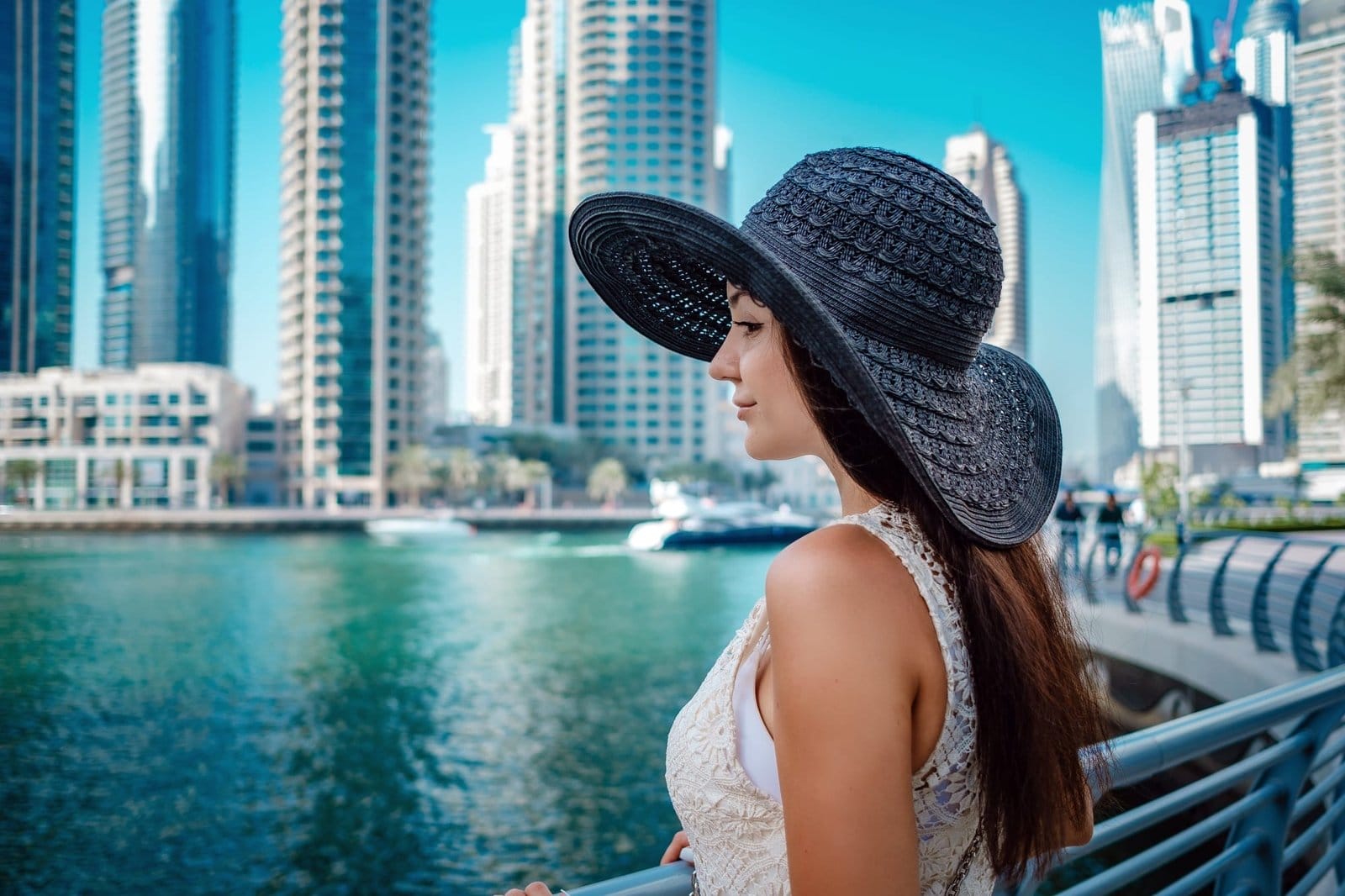 Happy young traveler woman in big city Dubai