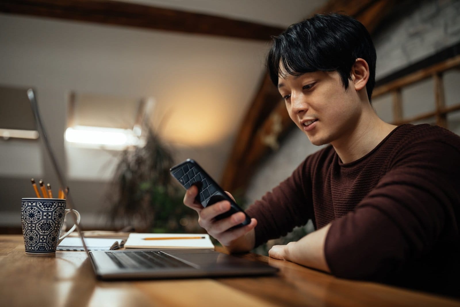 Japanese man using cellphone at home