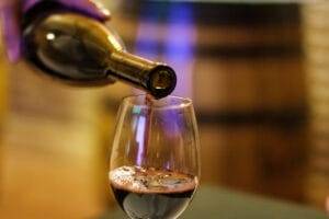 Pouring red wine in a wine glass