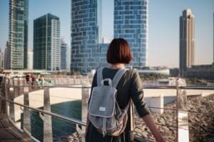 Happy young female traveler in the big city of Dubai, UAE