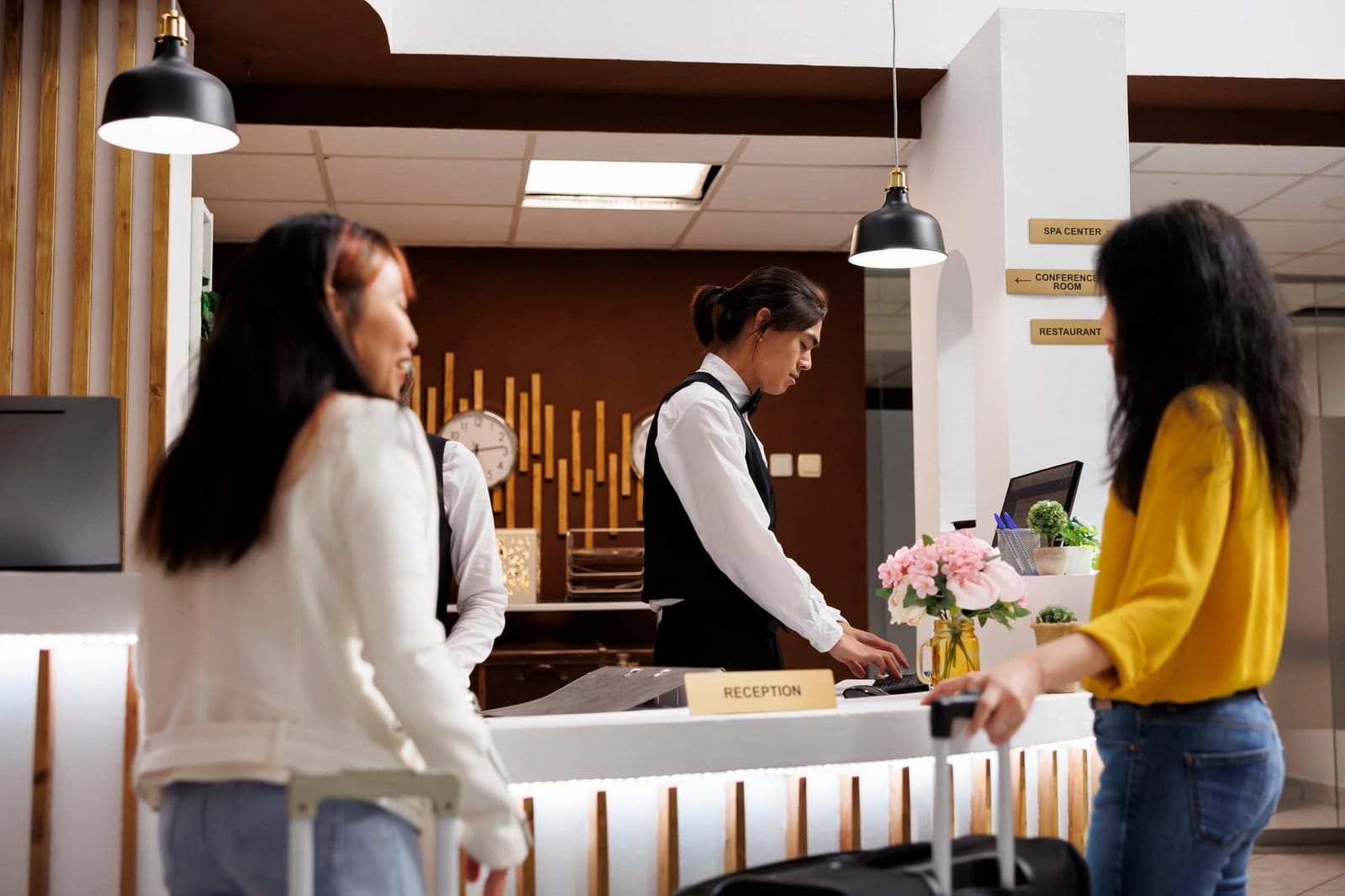 Hotel reception with two female guests