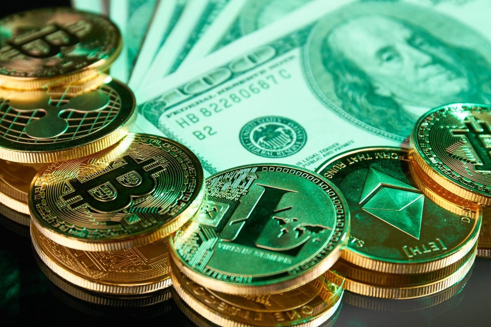 Real golden cryptocurrency coins and dollars close-up.