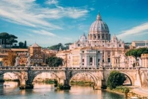 Rome, Italy. Man Training On Kayak Near Aelian Bridge. Papal Basilica Of St. Peter In The Vatican
