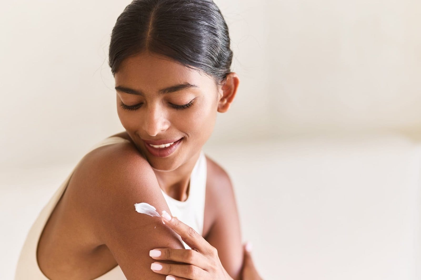 Woman Applying Cream for Smooth and Hydrated Skin Care Moment