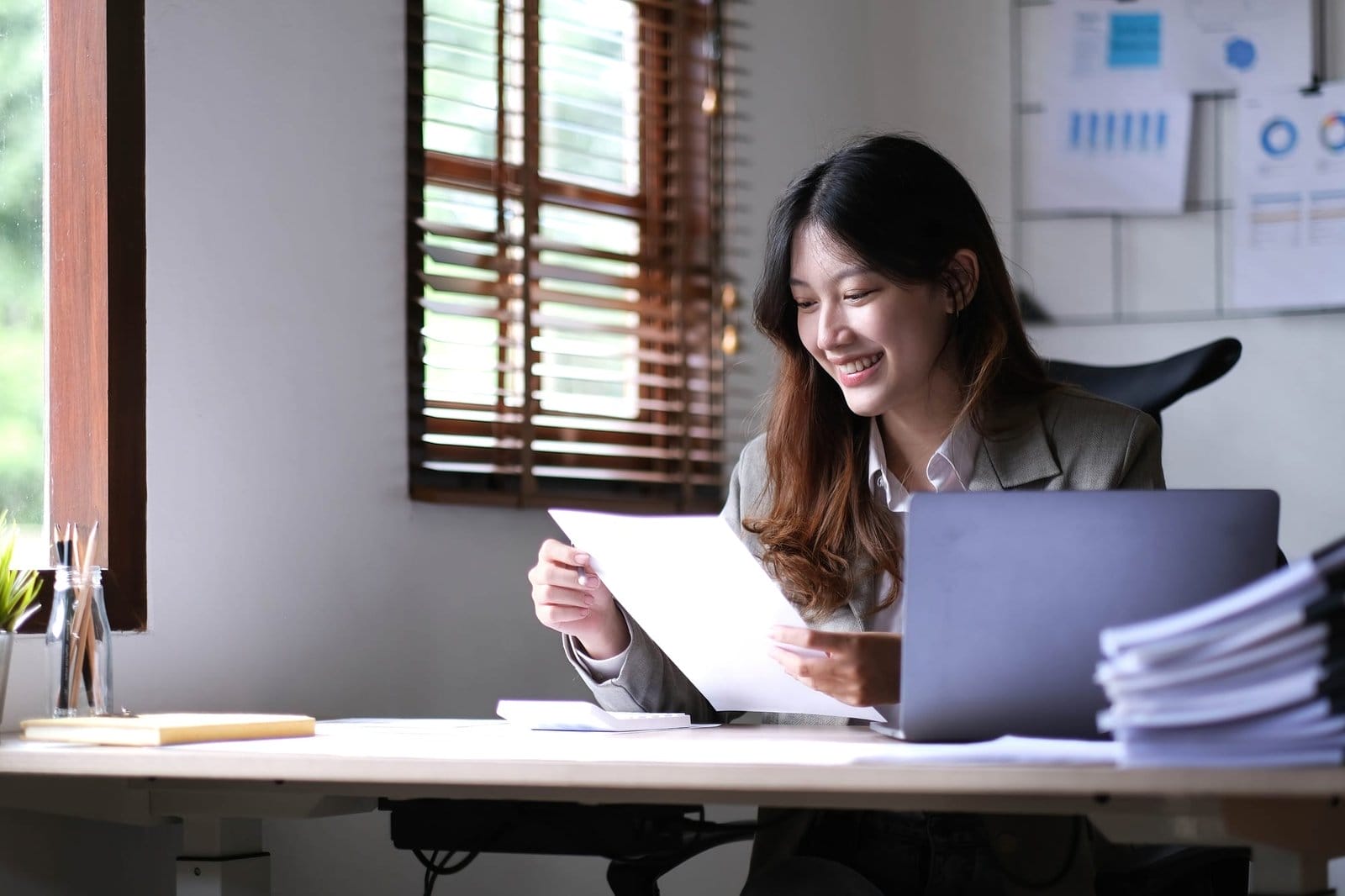 Asian businesswoman working in the office with working documents.