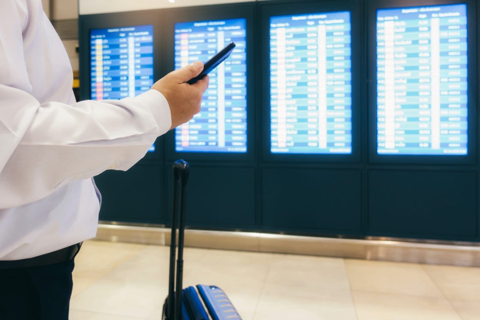 Businessman at airport checking the time