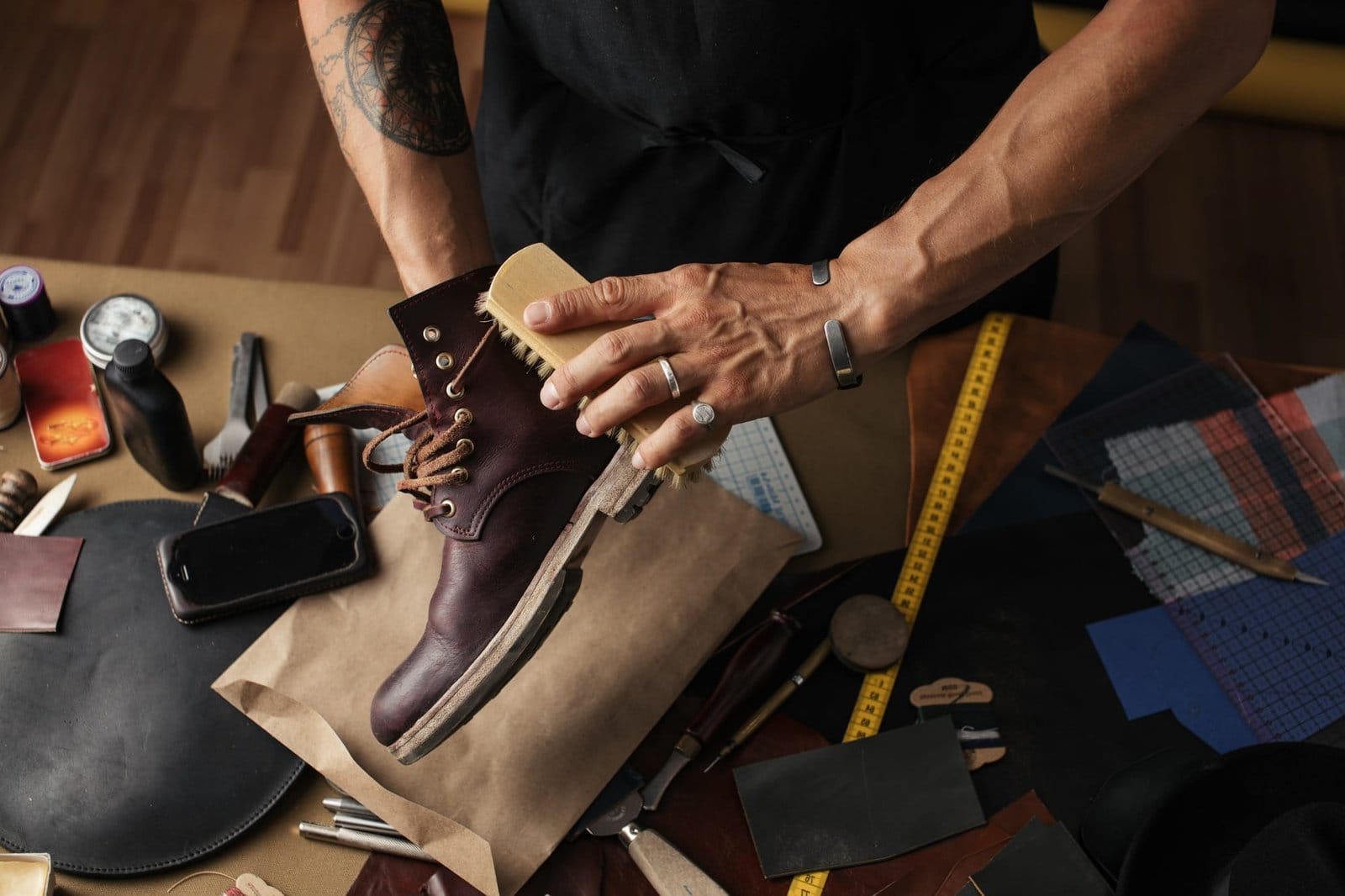 Cleaning shoes on wooden background. black shoe with a brush Cleaning shoes on wooden background. black shoe with a brush