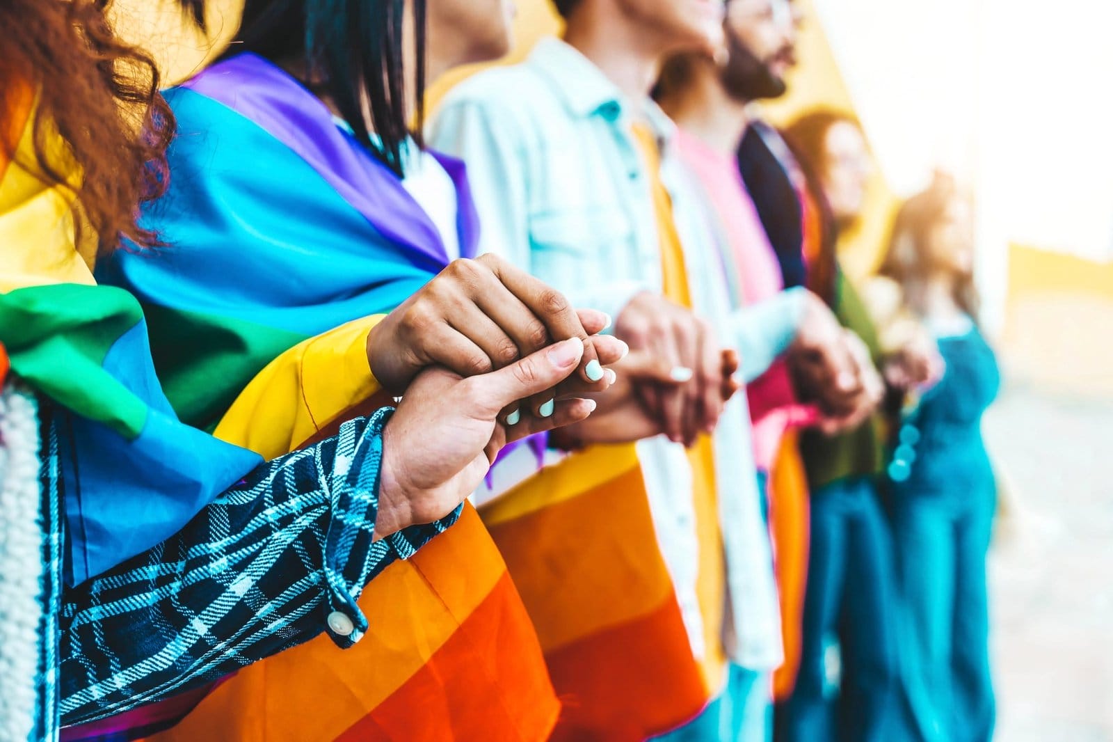 Group of lgbt people holding hands outside
