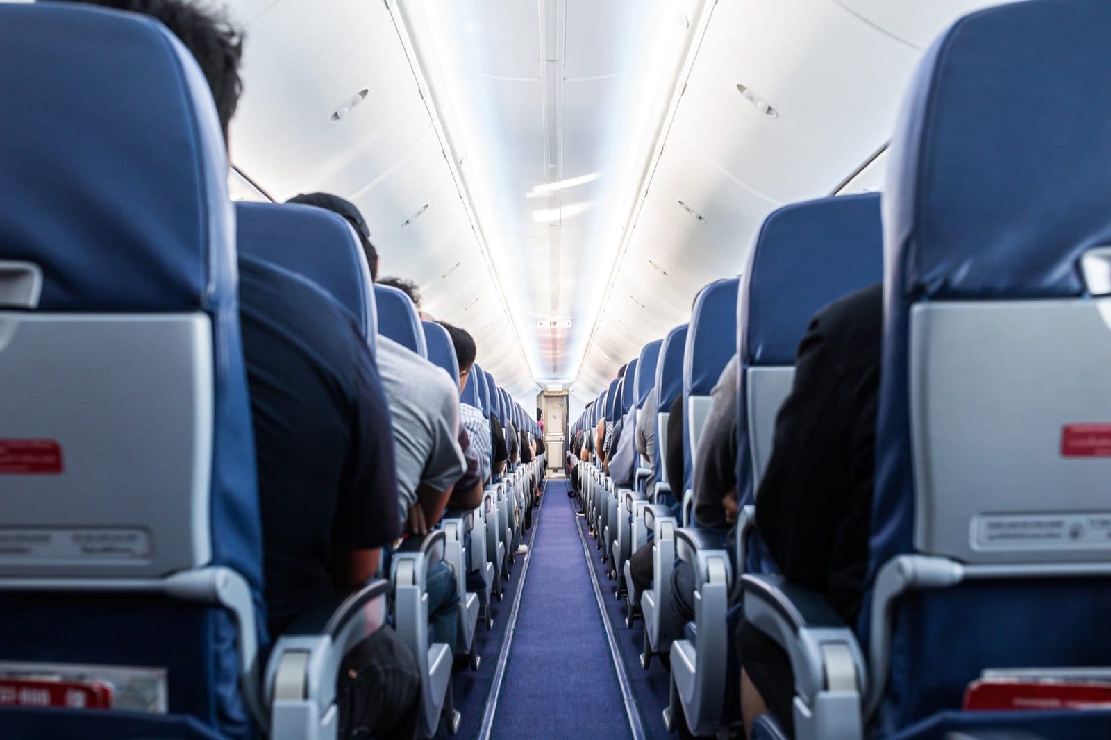 Passengers traveling by a plane, shot from the inside of an airplane