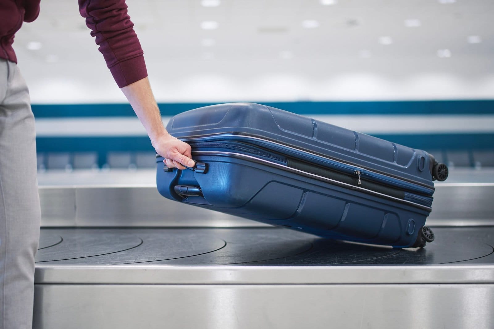 Suitcase in baggage claim in airport terminal