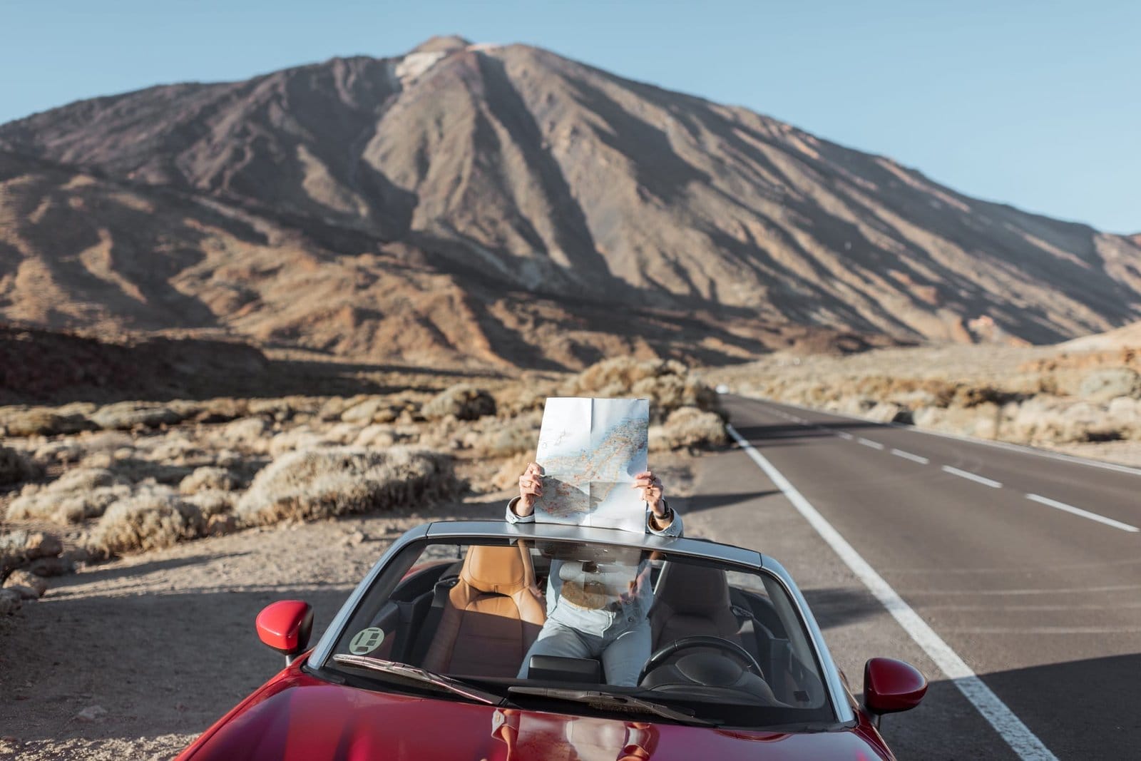 Woman traveling by car on the dessert valley