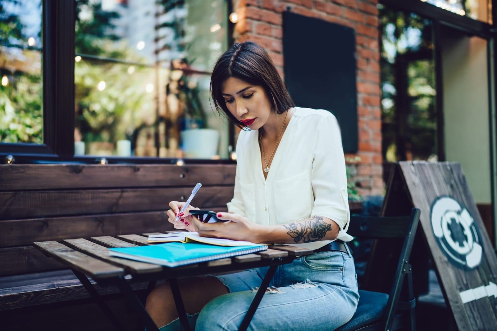 Young lady texting on cellphone in terrace